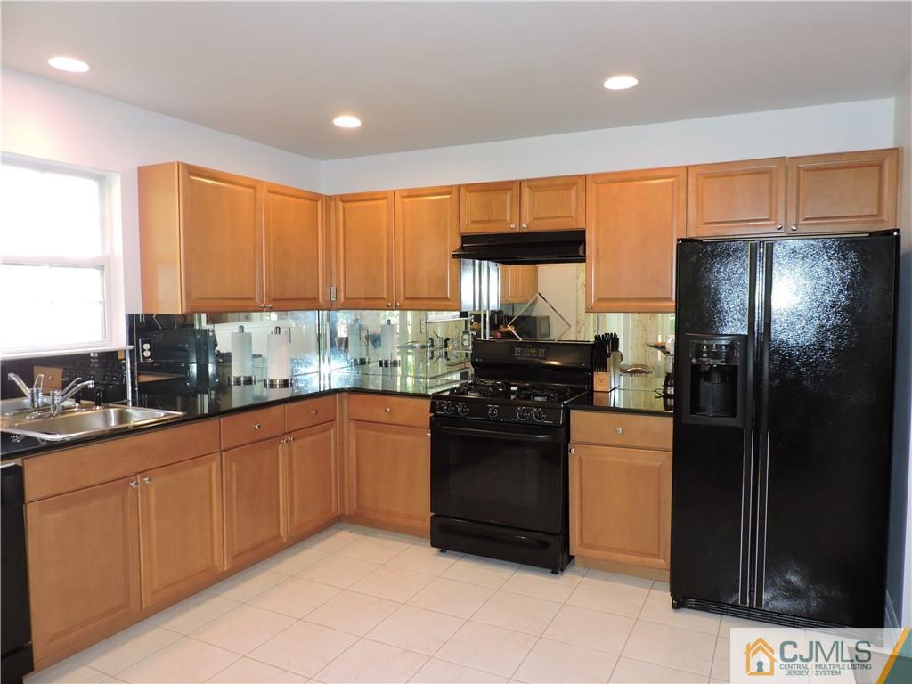 236 Hawthorne Road North Brunswick, NJ 08902 - Photo 8 of 25 a kitchen with stainless steel appliances granite countertop a refrigerator a sink a stove top oven and a refrigerator