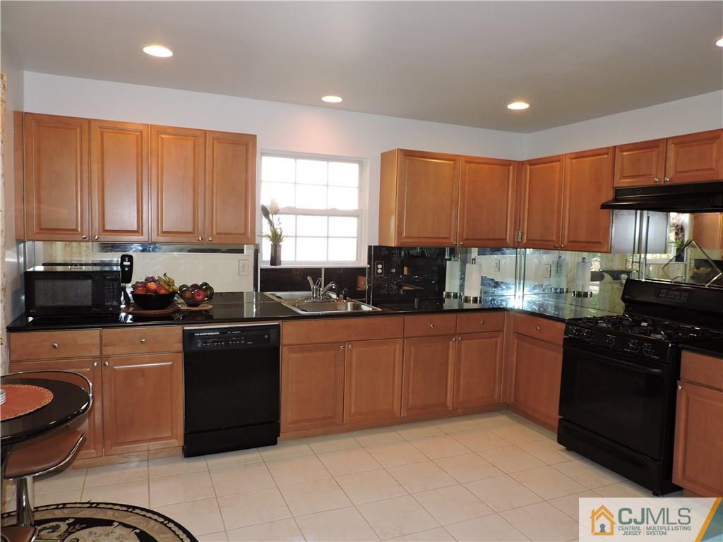 236 Hawthorne Road North Brunswick, NJ 08902 - Photo 9 of 25 a kitchen with stainless steel appliances granite countertop a stove a sink dishwasher and a microwave