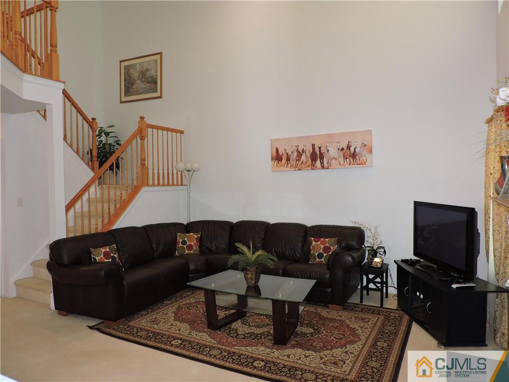 236 Hawthorne Road North Brunswick, NJ 08902 - Photo 10 of 25 a living room with furniture a rug and a flat screen tv