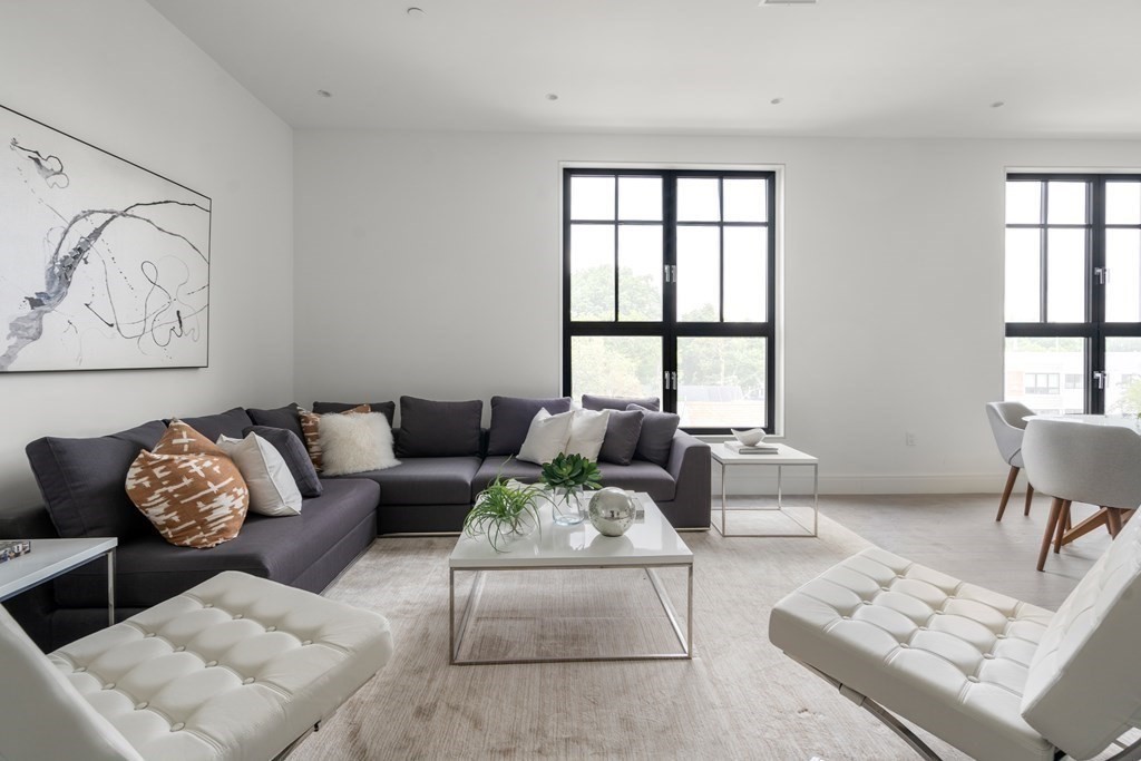 8 Leverett Street, Unit 1 Brookline, MA 02445 - Photo 1 of 29 a living room with furniture and windows