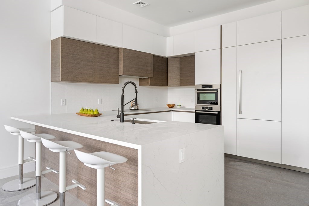 8 Leverett Street, Unit 1 Brookline, MA 02445 - Photo 14 of 29 a kitchen with stainless steel appliances a sink and a refrigerator