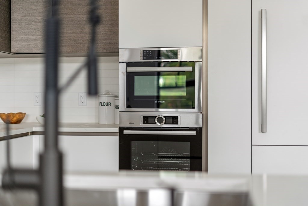 8 Leverett Street, Unit 1 Brookline, MA 02445 - Photo 17 of 29 a kitchen with stainless steel appliances a stove and a refrigerator