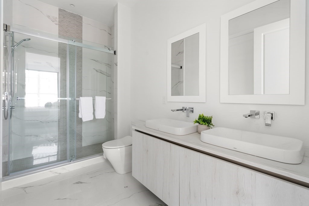 8 Leverett Street, Unit 1 Brookline, MA 02445 - Photo 21 of 29 a bathroom with a sink and a mirror