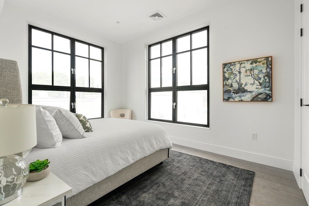 8 Leverett Street, Unit 1 Brookline, MA 02445 - Photo 22 of 29 a bedroom with a large bed and a window