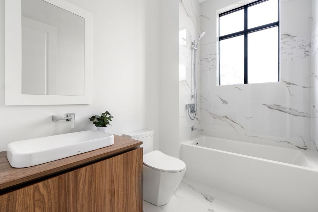 8 Leverett Street, Unit 1 Brookline, MA 02445 - Photo 23 of 29 a bathroom with a sink a toilet and shower