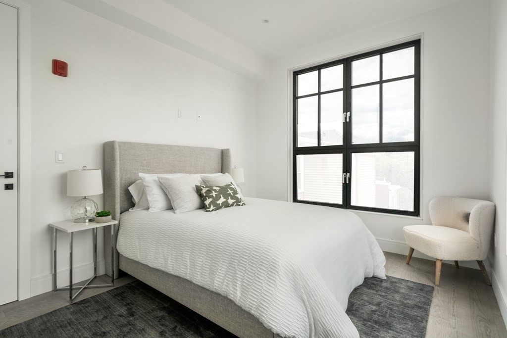 8 Leverett Street, Unit 1 Brookline, MA 02445 - Photo 24 of 29 a bedroom with a bed and a large window