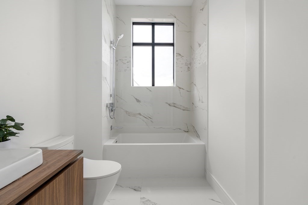 8 Leverett Street, Unit 1 Brookline, MA 02445 - Photo 25 of 29 a white bath tub sitting next to a white toilet
