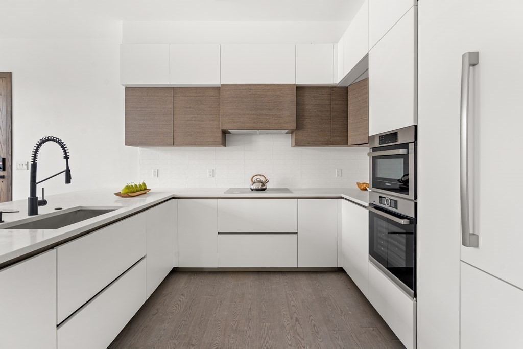 8 Leverett Street, Unit 1 Brookline, MA 02445 - Photo 3 of 29 a kitchen with a sink and stainless steel appliances
