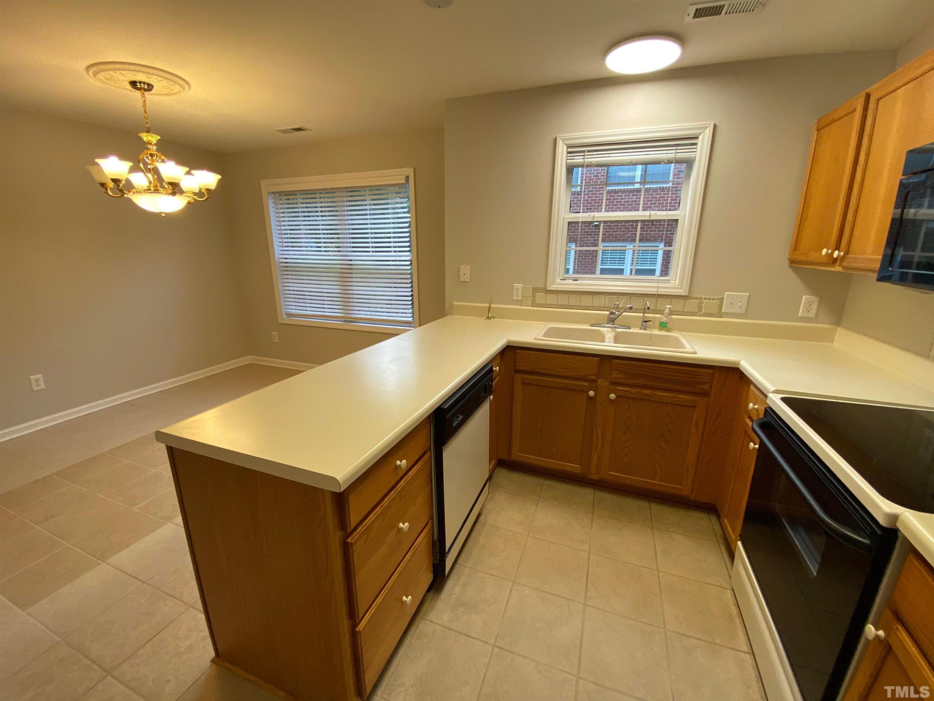 2413 Wellington Ridge Loop, Unit 2413 Cary, NC 27518 - Photo 14 of 30 a kitchen with a sink a counter top space and appliances