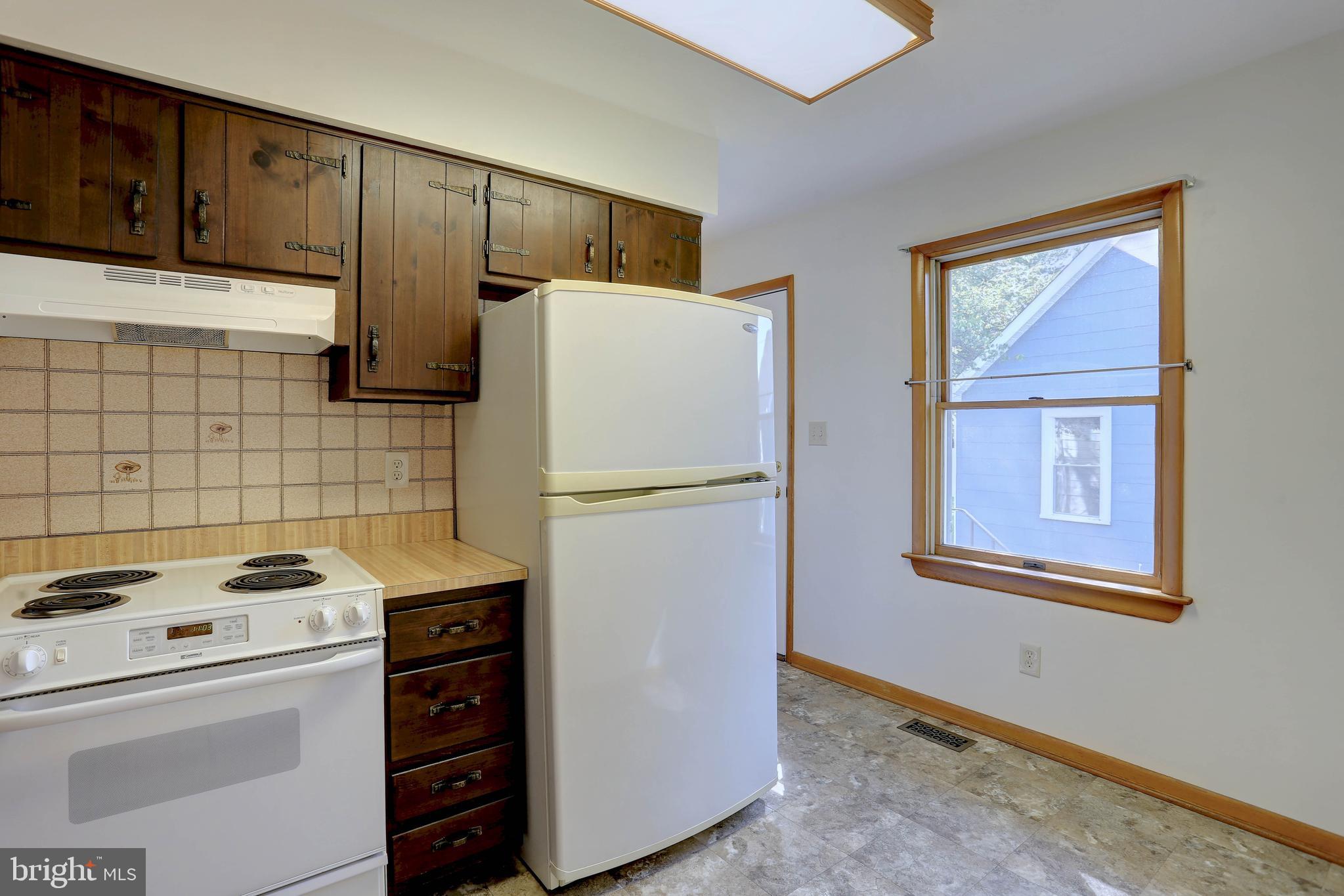 207 Greenland Beach Road Baltimore, MD 21226 - Photo 13 of 28 a white refrigerator freezer and a stove sitting inside of a kitchen