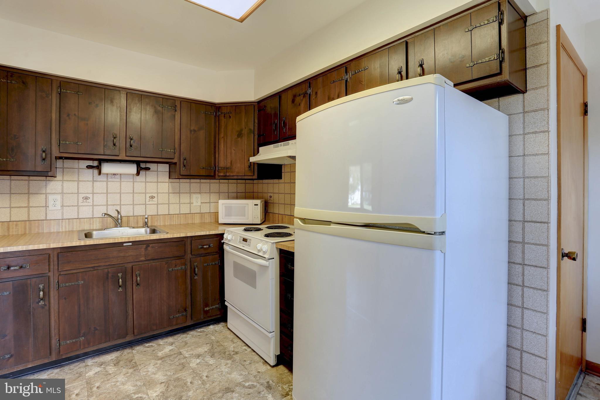 207 Greenland Beach Road Baltimore, MD 21226 - Photo 14 of 28 a utility room with cabinets washer and dryer