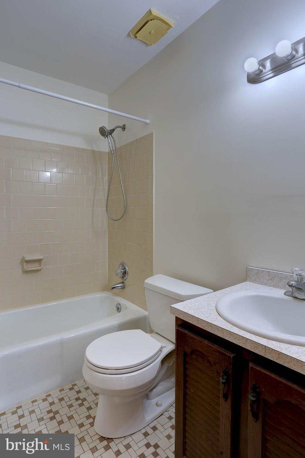 207 Greenland Beach Road Baltimore, MD 21226 - Photo 23 of 28 a bathroom with a sink a toilet and shower