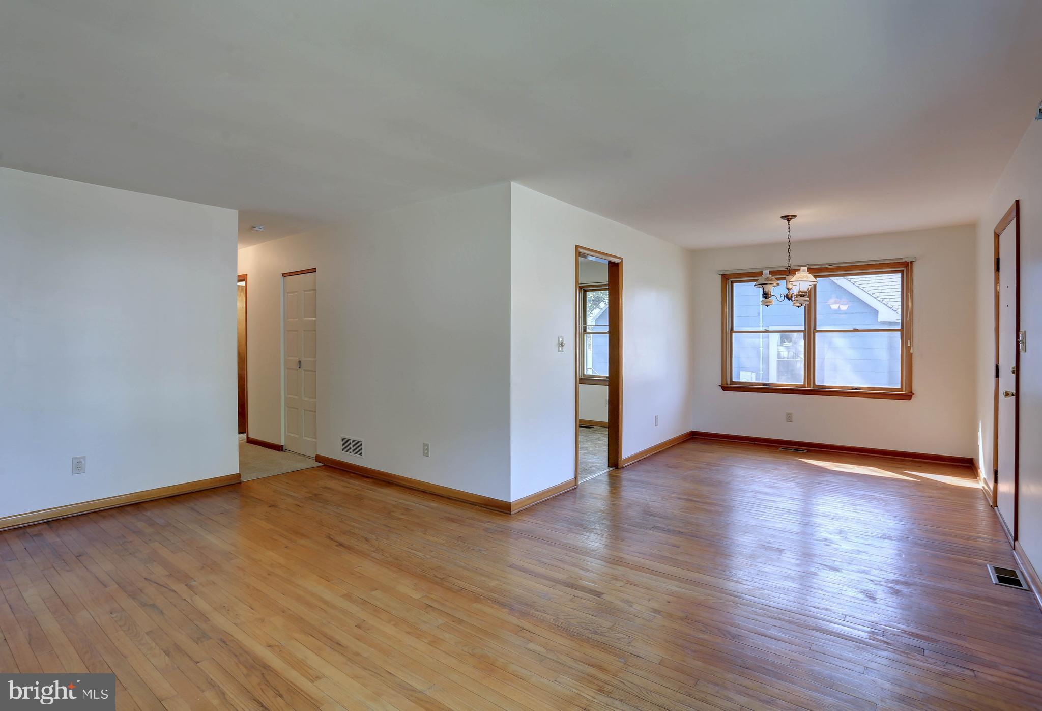 207 Greenland Beach Road Baltimore, MD 21226 - Photo 8 of 28 an empty room with wooden floor and windows