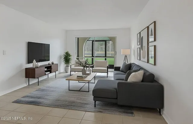 a living room with furniture and a flat screen tv