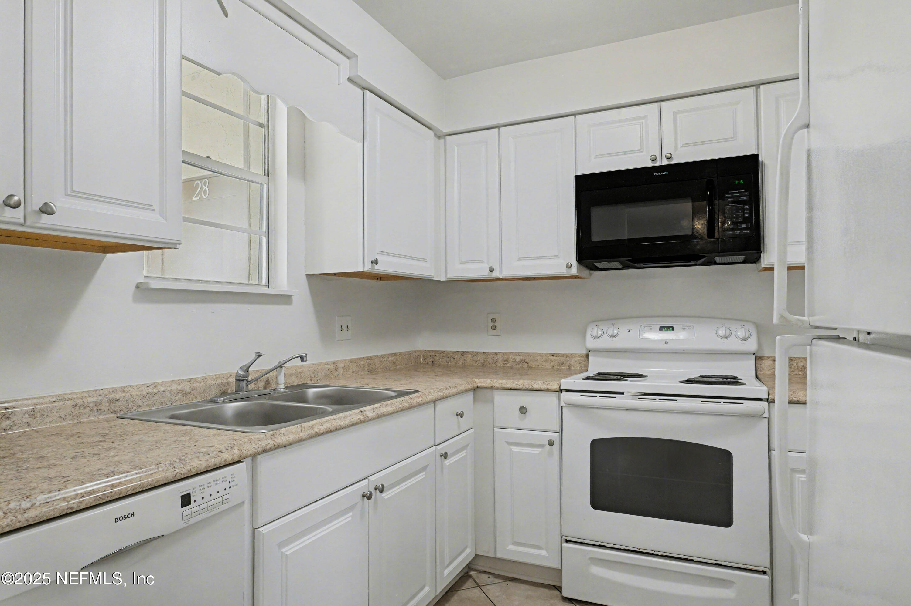 1530 El Prado Road, Unit 1 Jacksonville, FL 32216 - Photo 6 of 15 a kitchen with stainless steel appliances granite countertop a sink a stove and microwave