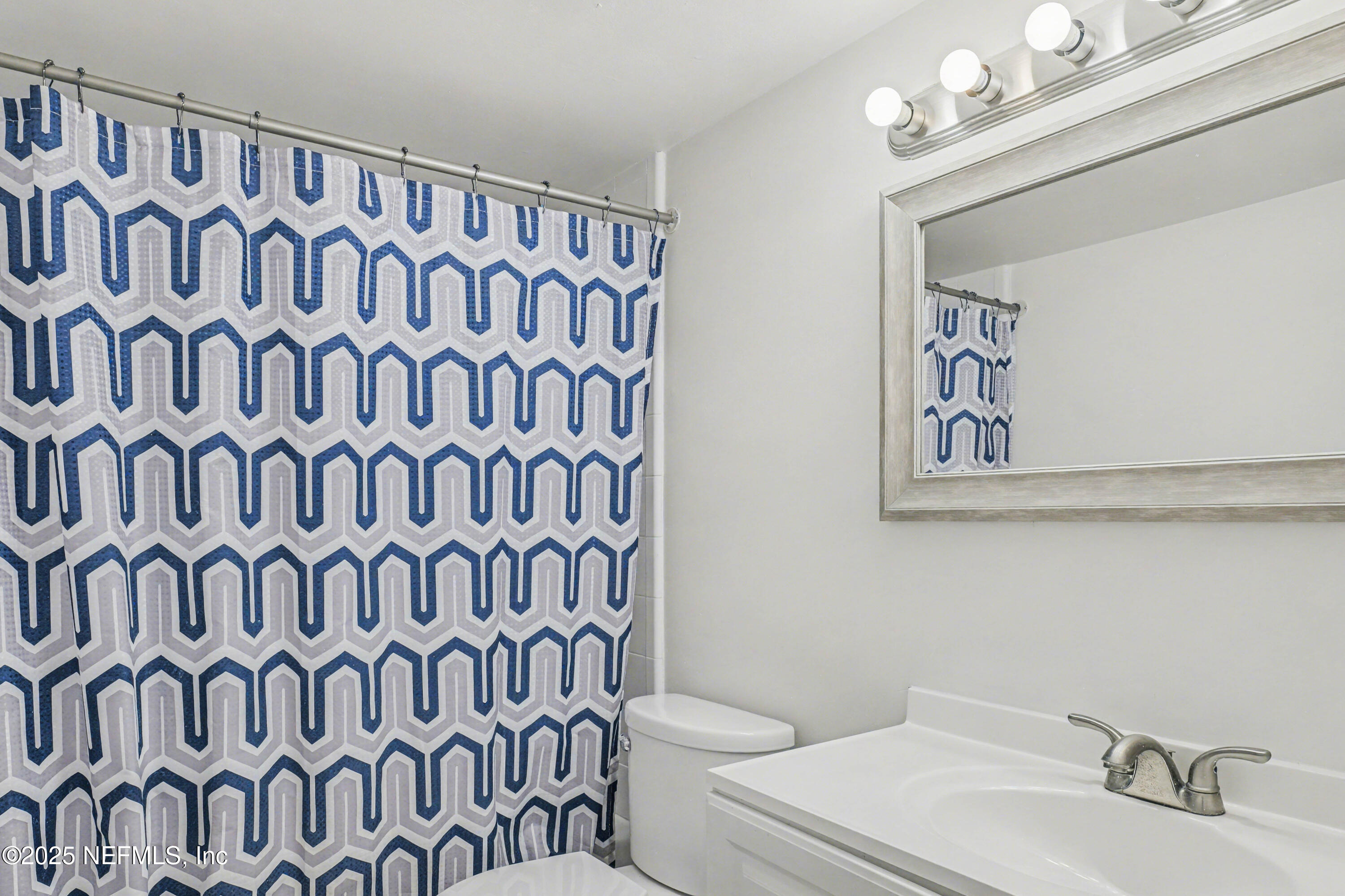 1530 El Prado Road, Unit 1 Jacksonville, FL 32216 - Photo 9 of 15 a bathroom with a sink a toilet and a mirror