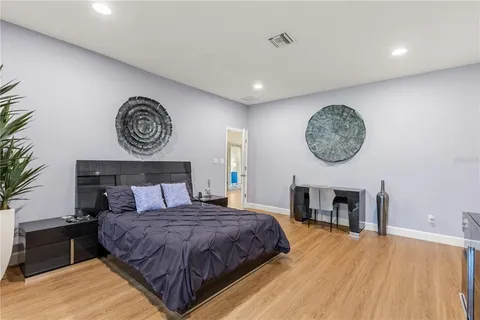 a spacious bedroom with a bed and a fireplace