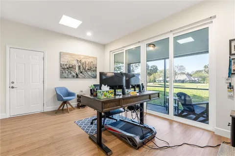 a work room with furniture and a floor to ceiling window