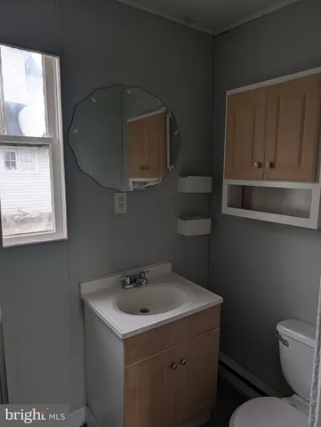 a bathroom with a toilet sink and mirror
