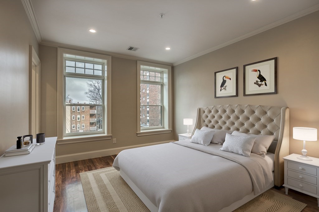 a bedroom with a large bed and a window
