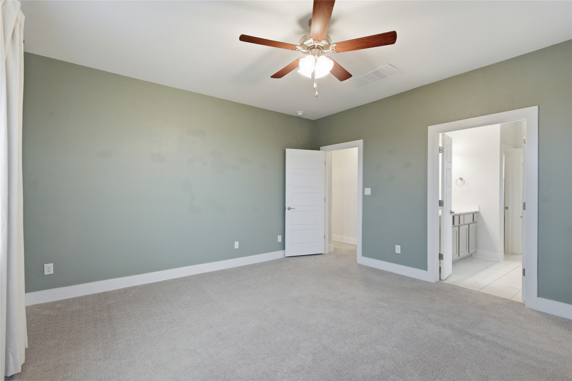 1300 Harwell Loop Kyle, TX 78640 - Photo 13 of 21 an empty room with a chandelier fan and a ceiling fan