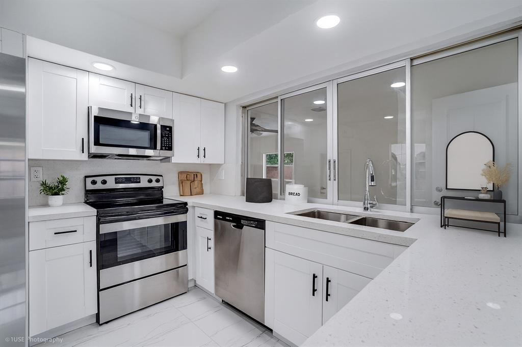 4971 Southwest 7th Court Margate, FL 33068 - Photo 4 of 15 a kitchen with appliances a sink and cabinets