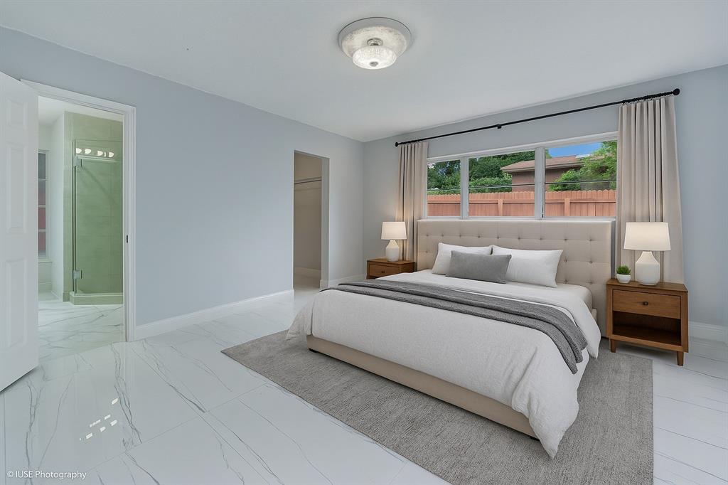 4971 Southwest 7th Court Margate, FL 33068 - Photo 5 of 15 a bedroom with a bed and a large window