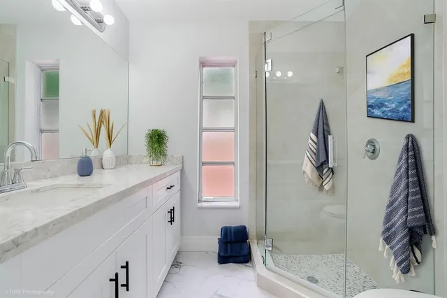 a bathroom with a double vanity sink and a mirror