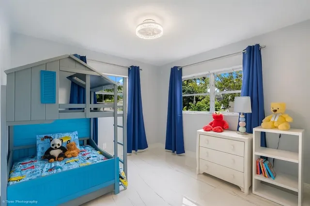 a living room with furniture toys and a window