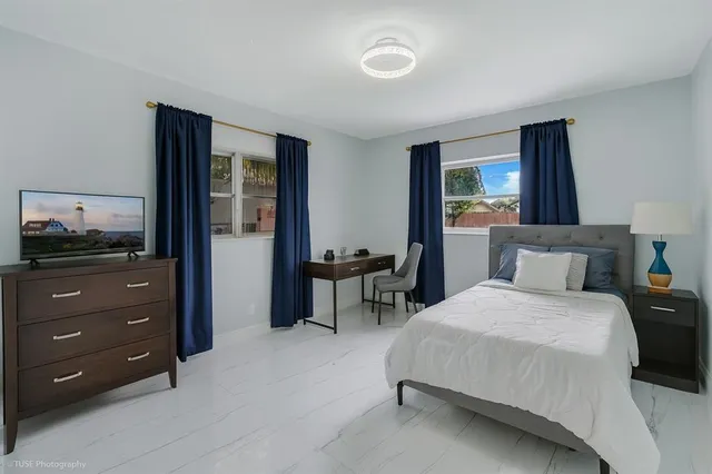 a bedroom with a bed and a dresser in it