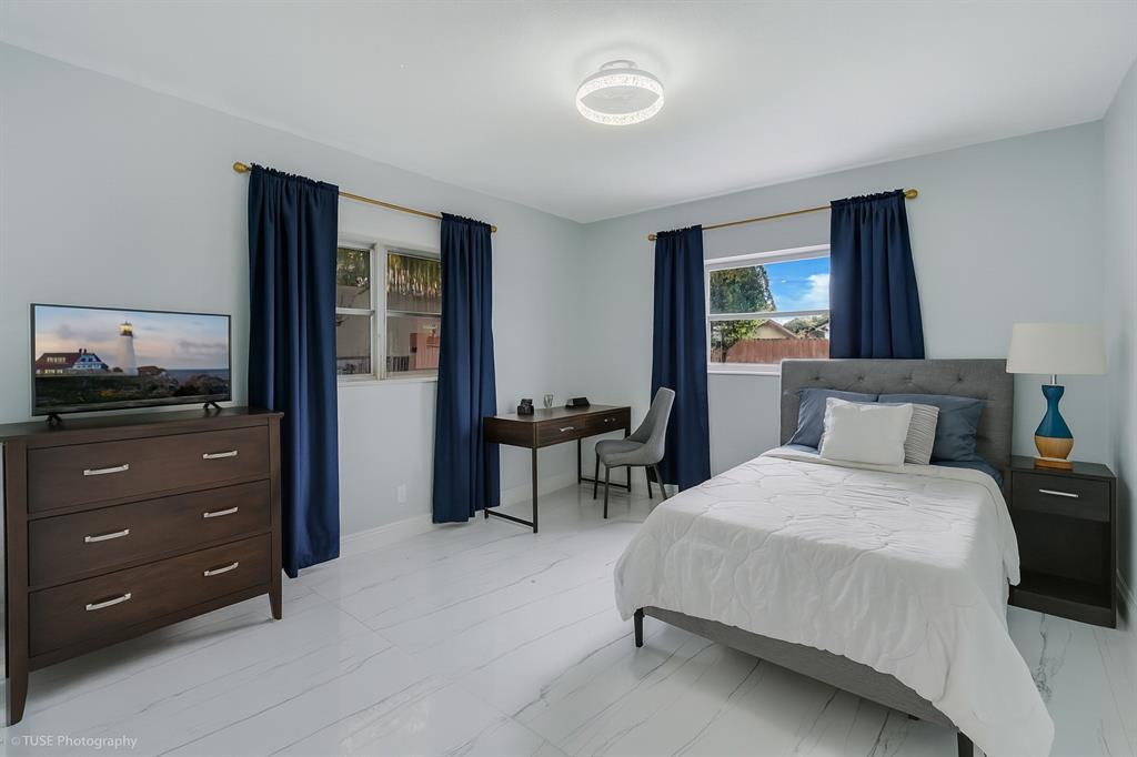 4971 Southwest 7th Court Margate, FL 33068 - Photo 10 of 15 a bedroom with a bed and a dresser in it