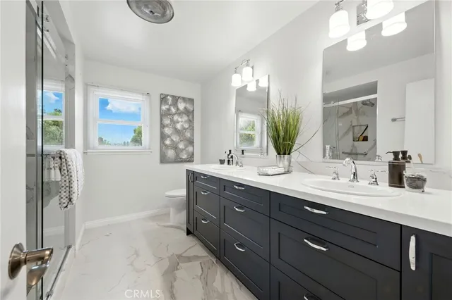 a bathroom with a double vanity sink a vanity and a mirror
