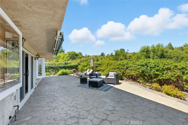 a view of a terrace with chairs and a potted plant