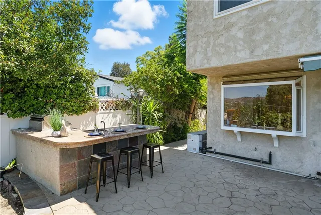 a view of a house with backyard and sitting area