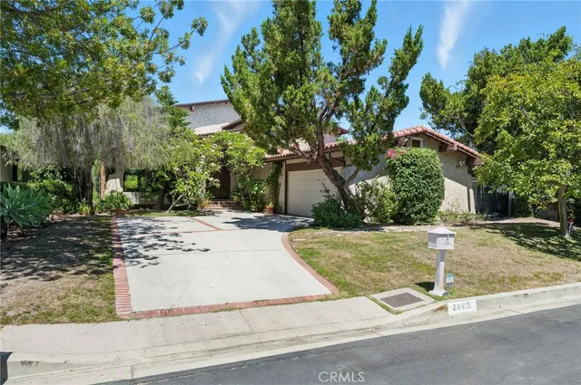 front view of a house with a tree
