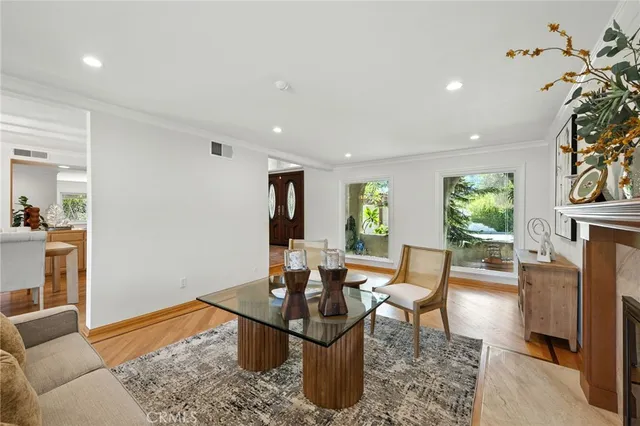 a living room with furniture a fireplace and a potted plant