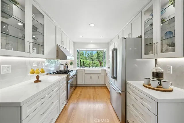 a kitchen with a sink stove and refrigerator