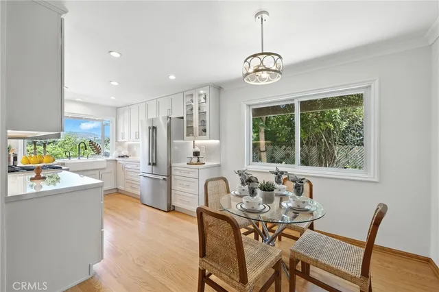 a dining room with furniture a chandelier and wooden floor