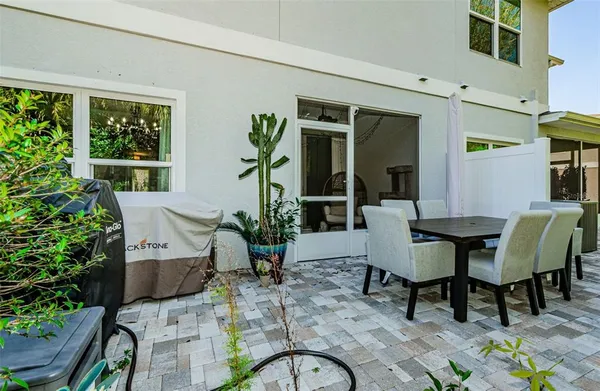 a backyard of a house with table and chairs