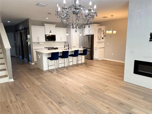 a view of kitchen with cabinets and wooden floor