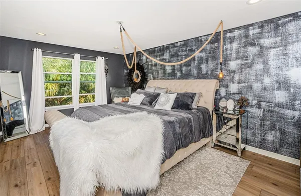 a bed sitting in a bedroom next to a window