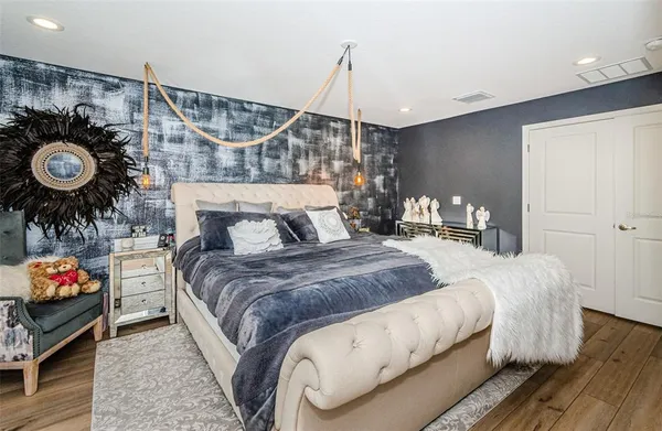 a bedroom with a bed and a chandelier