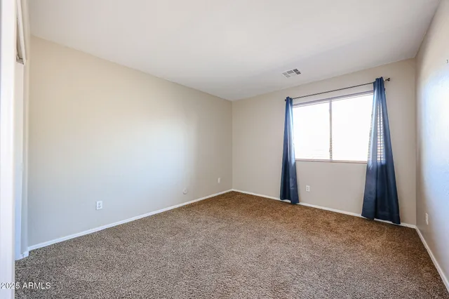 a view of an empty room and entryway