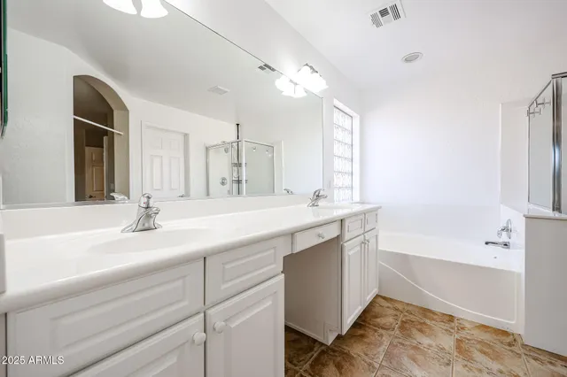a bathroom with a bathtub and shower