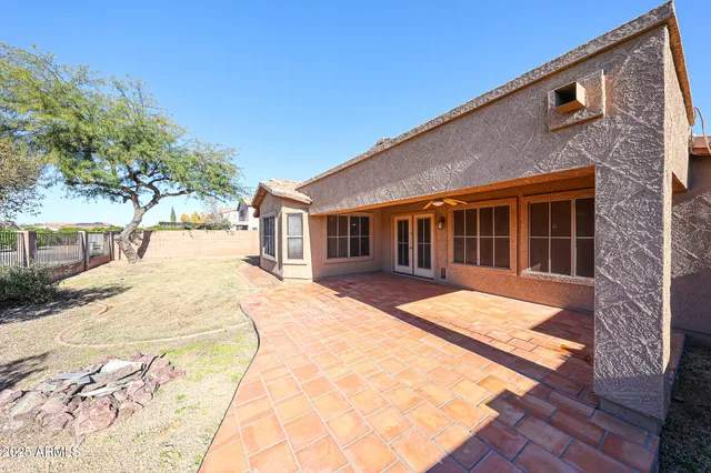 a view of a house with a backyard