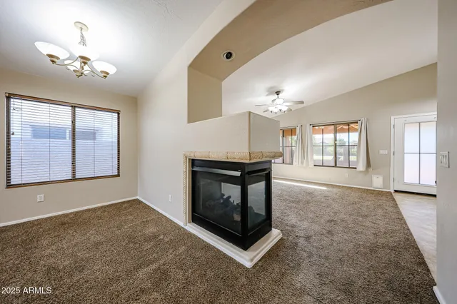 a living room with furniture a chandelier and a window