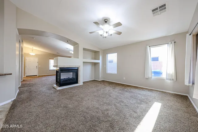 a view of empty room with a fireplace