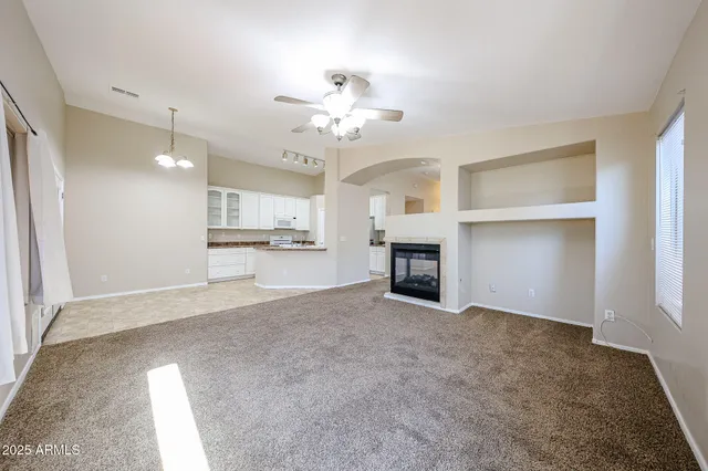 a view of an empty room with a kitchen