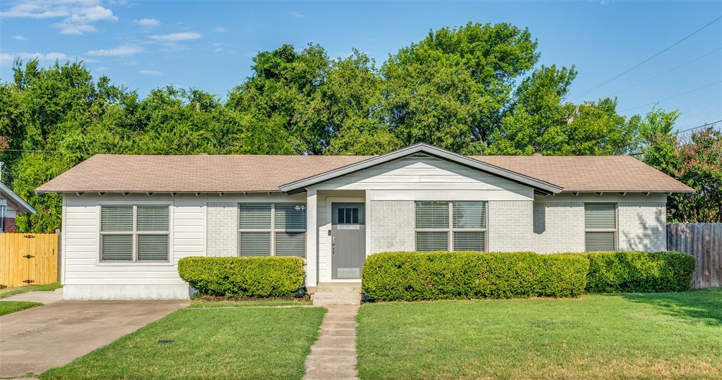 View of front of property featuring a shingled roof and brick siding