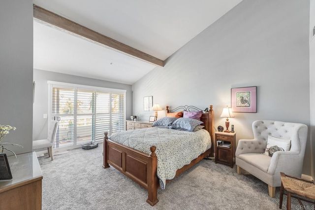 a spacious bedroom with a bed and glass window
